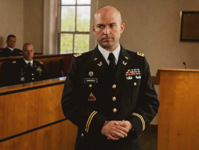 An Officer in the U.S. Army Judge Advocate General’s Corps (JAG) stands in a courtroom 