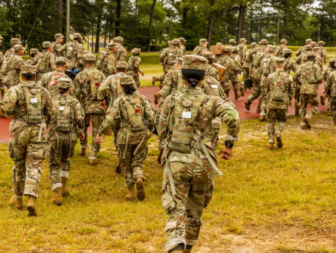 A group of trainees running outdoors during Basic Combat Training