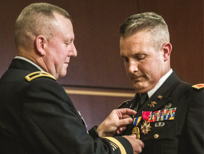 A male decorated Officer receiving a medal