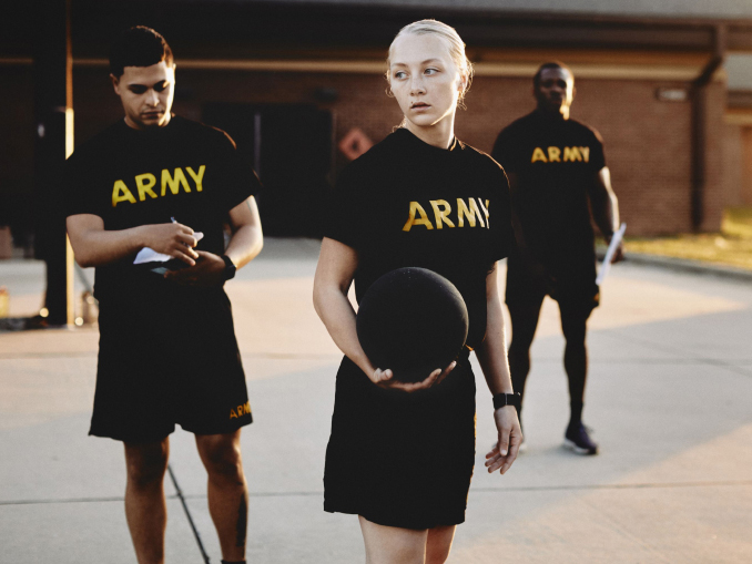 Two males and a female wearing Army tee shirts preparing for a fitness test