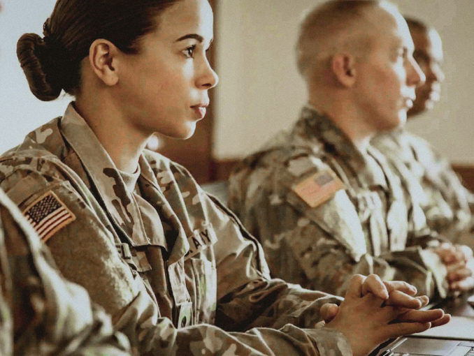 Soldiers in uniform sitting in a classroom