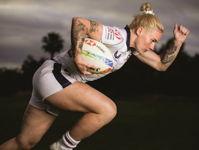 A female World Class Athlete running with a Rugby ball