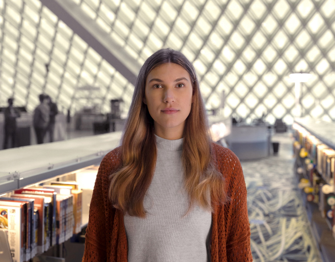 A female student standing in a library