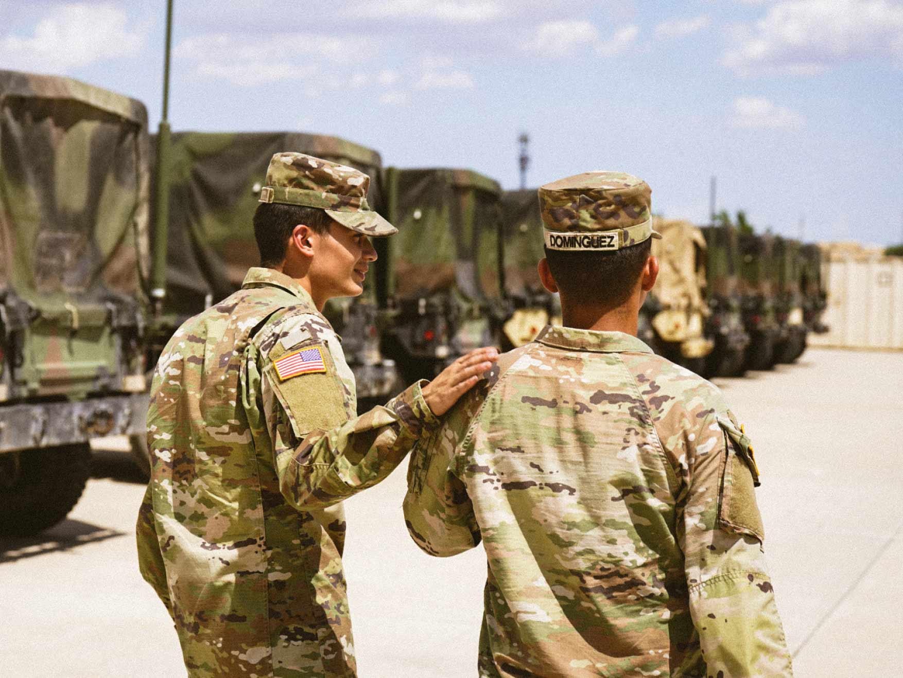 Two Soldiers walking through a parking lot having a conversation